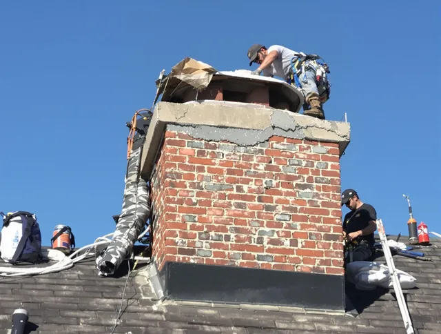 Moreno Valley Chimney Sweep installing a custom chimney crown in Moreno Valley, CA